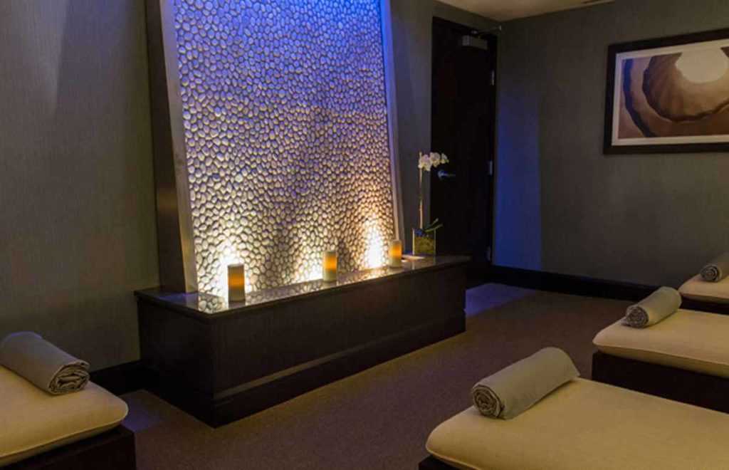 inside a massage room with a relaxing waterfall in dim room