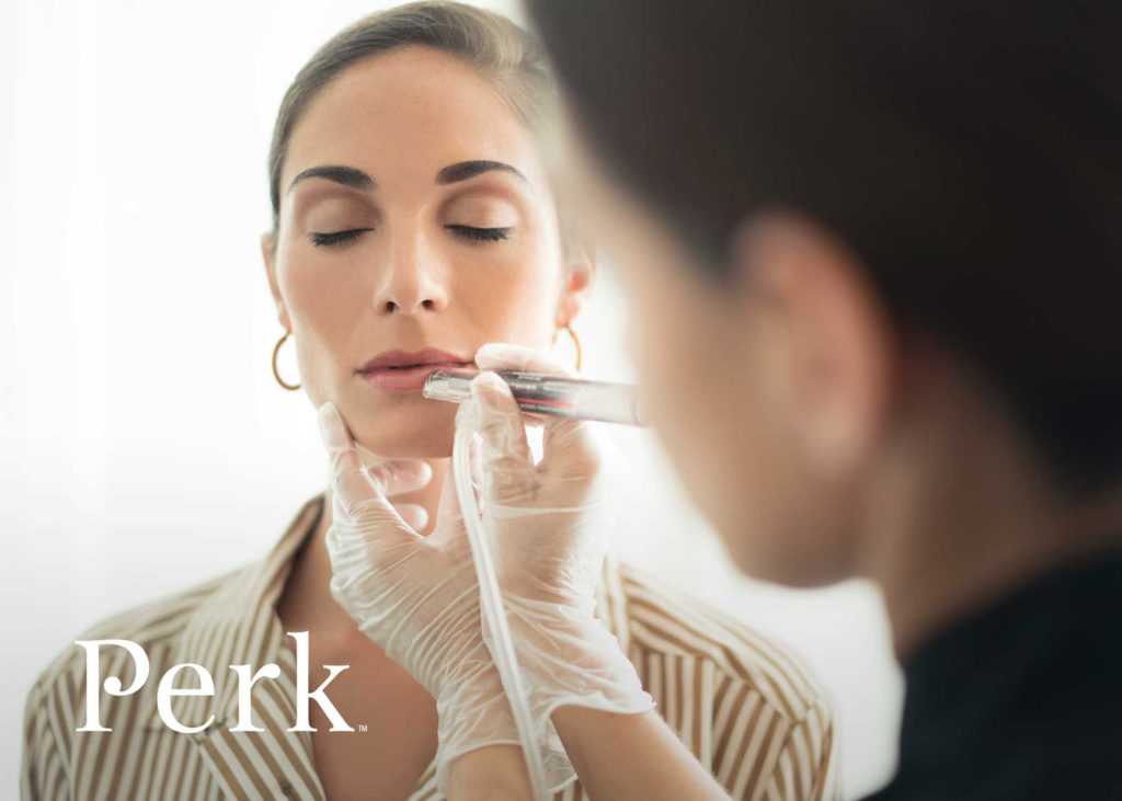 a perk lip technician working on the lips of a woman