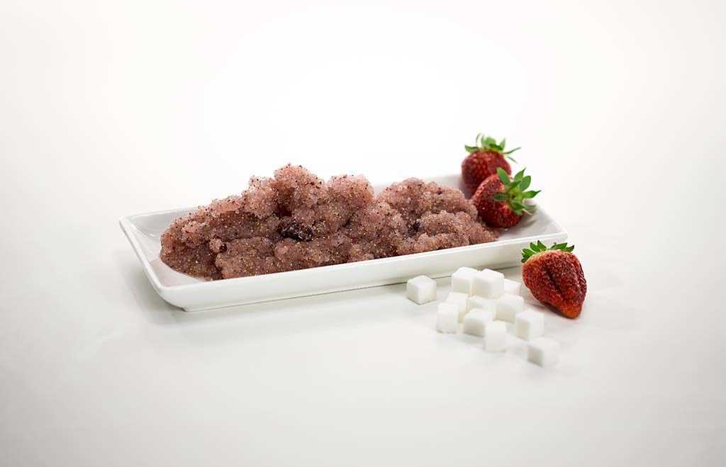 strawberries and sugar cubes on a white rectangular plate