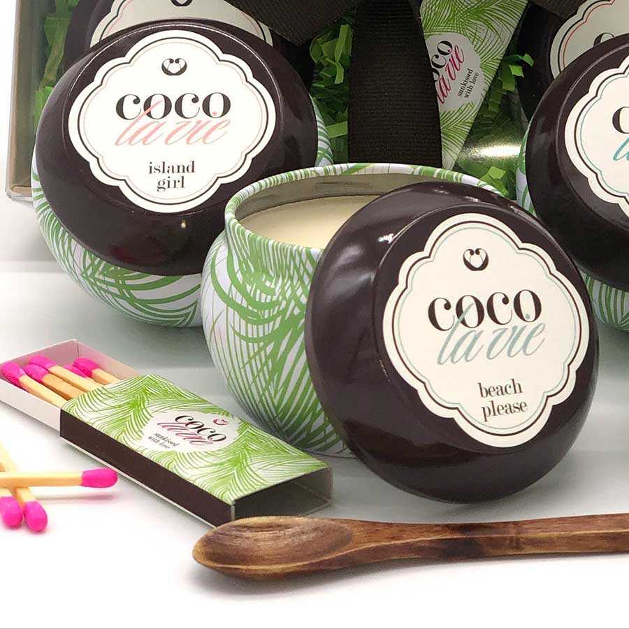 coco la vie candles in palm frond decorated jars with branded matchbox