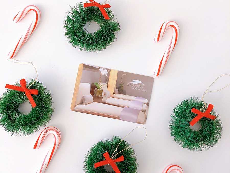 candy canes and christmas wreaths surrounding a spa gift card