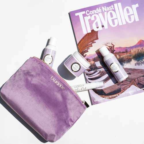 travel bag with various lotions atop a conde nast traveller magazine
